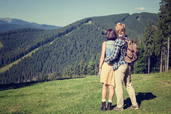 Pareja joven de viajeros disfrutando de vistas a la montaña — Foto de Stock