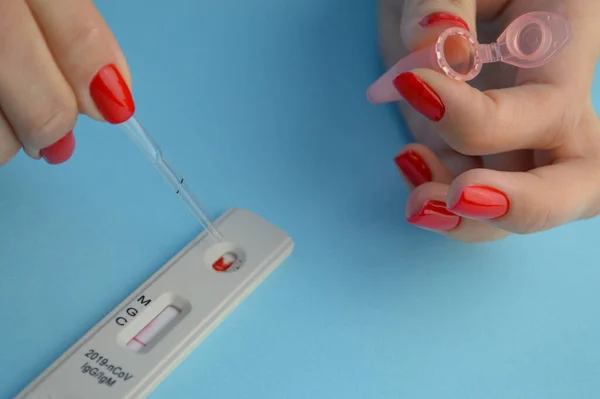 İgm ve IgG antikorları için COVID-19 testi yapın. Yeni Coronavirus SARS-CoV-2, Covid-19. Nitril eldivenli hemşire hasta kanını tek kullanımlık pipetle topluyor..