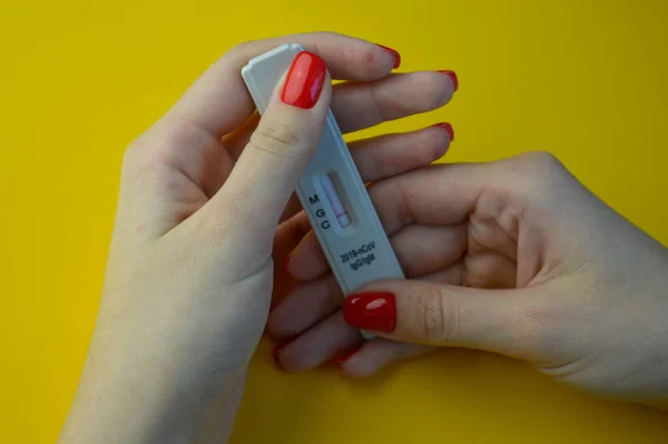 Test for antibodies to coronavirus infection. Checking the population for immunity to covid 19. A test tube with a blood test in hands of a doctor against the background of laboratory research.