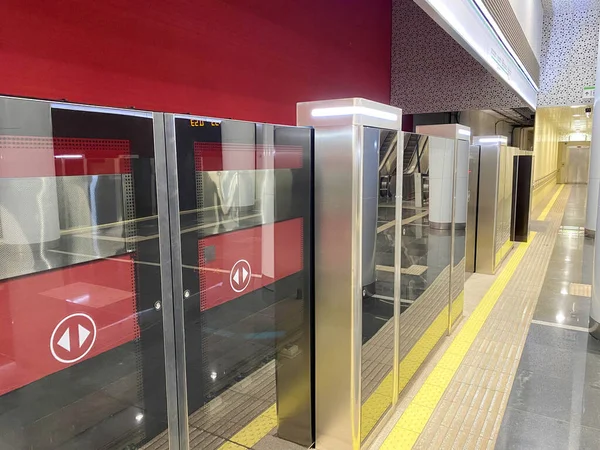 Automatic door platform system at a new modern metro station. Metro security system glass beautiful doors open synchronously with the doors of the arriving train car.