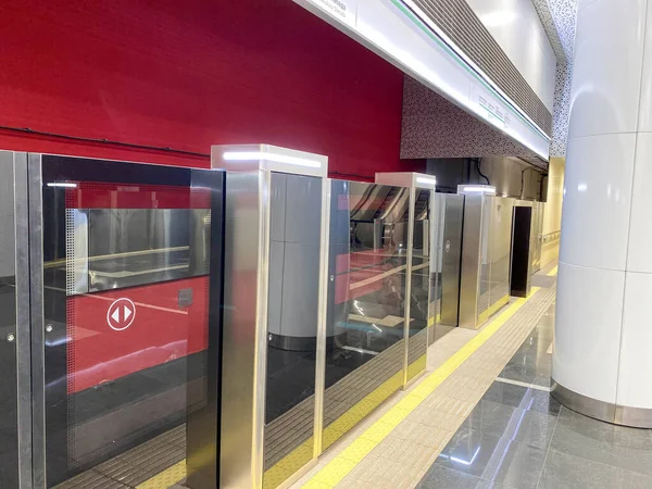 Automatic door platform system at a new modern metro station. Metro security system glass beautiful doors open synchronously with the doors of the arriving train car.