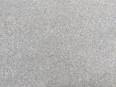 Küçük taşlı, yeni, gri, sert asfalt bir yol. Arka plan. Doku.