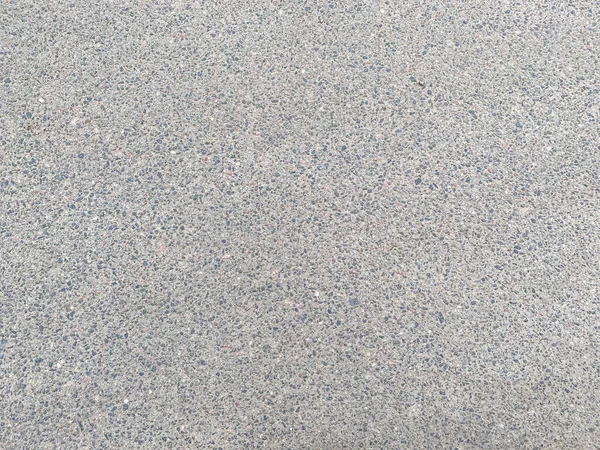 Küçük taşlı, yeni, gri, sert asfalt bir yol. Arka plan. Doku.