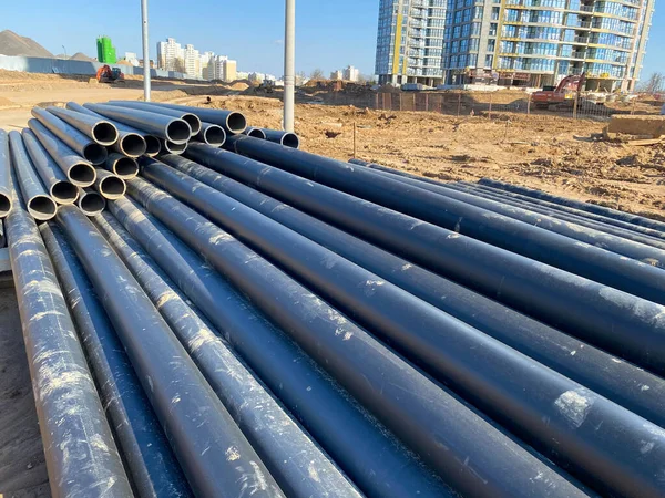 Large industrial black plastic polypropylene modern large diameter plumbing plumbing pipes at construction site in water pipe laying and construction and renovation of buildings and houses.
