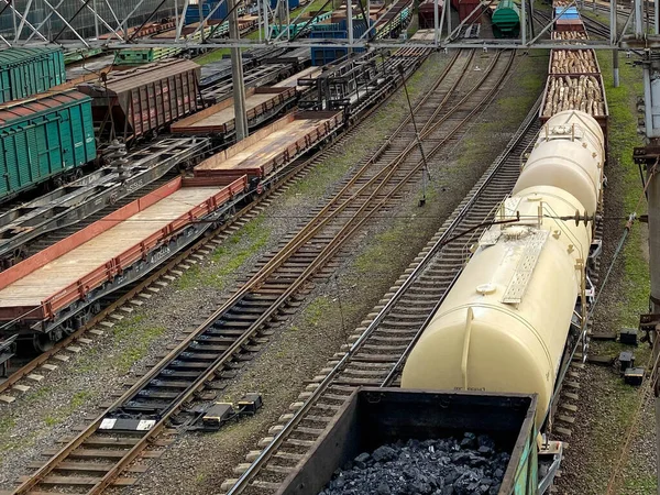 Top view of a railway marshalling yard with railroad cars. Coal industry. Commodity train with coal. Coal wagons, coal transportation in freight wagons. Formation of a coal train in a freight depot.