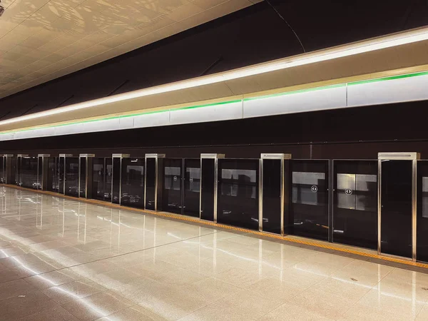 New modern safety screen with sliding doors for the safety of the metro train in the big city on the waiting platform in the metro station at the train station.