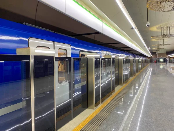 New blue modern subway train high speed fast safe in the big city on the waiting platform at the subway station at the train station.