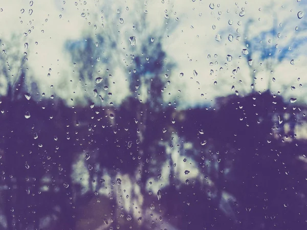 Beautiful surface texture of wet transparent glass in a window with clean cold drops after rain. The background.