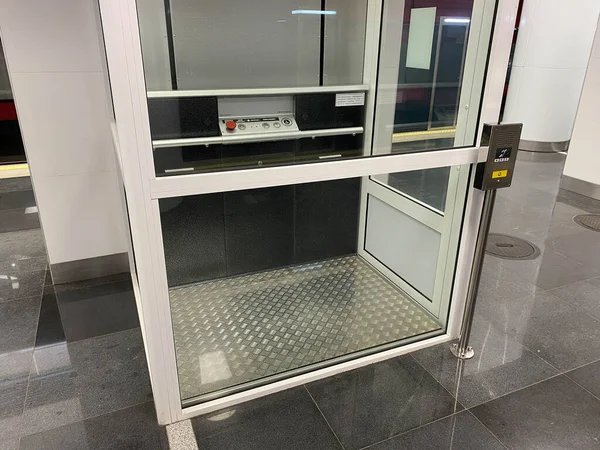 Large new inclusive elevator in the metro or shopping center for people with disabilities and people with disabilities for a barrier-free city environment.