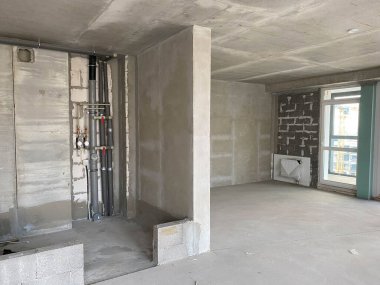 Tamir öncesi boş oda. Gri duvarlar tamamlanmamış.