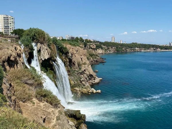 Waterfall on a steep shore by the sea.