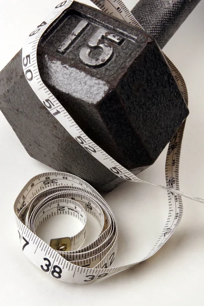 Dumbbell and measuring  tape — Stock Photo, Image