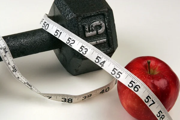 Dumbbell and measuring  tape — Stock Photo, Image