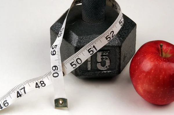 Dumbbell and measuring  tape — Stock Photo, Image