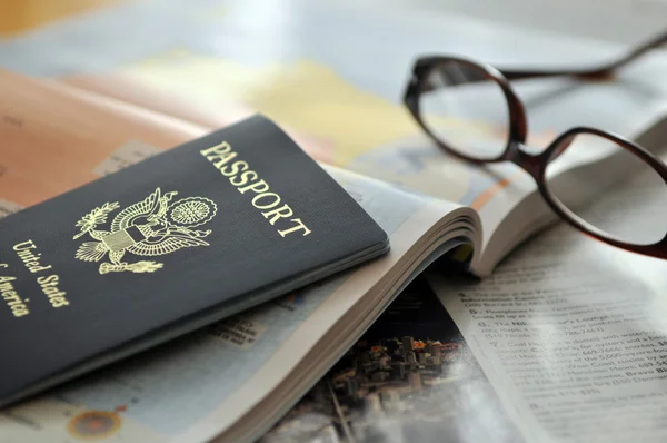 Pasaporte y gafas en el atlas —  Fotos de Stock