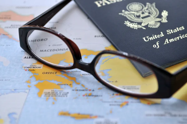 Pasaporte y gafas en el atlas — Foto de Stock