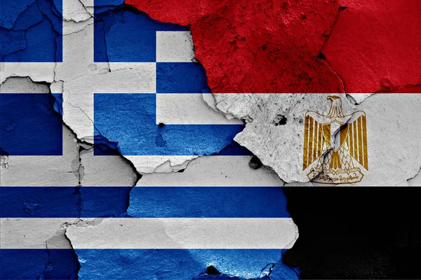 flags of Greece and Egypt painted on cracked wall