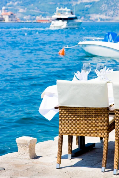 Table in the restaurant on the sea background — Stock Photo, Image