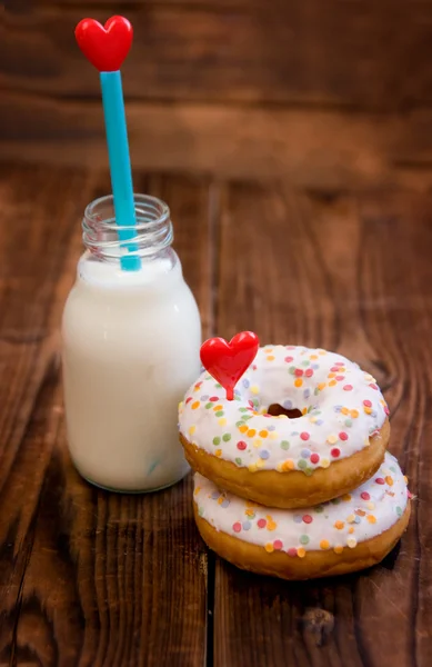 Doughnuts with heart and milk — Stock Photo, Image