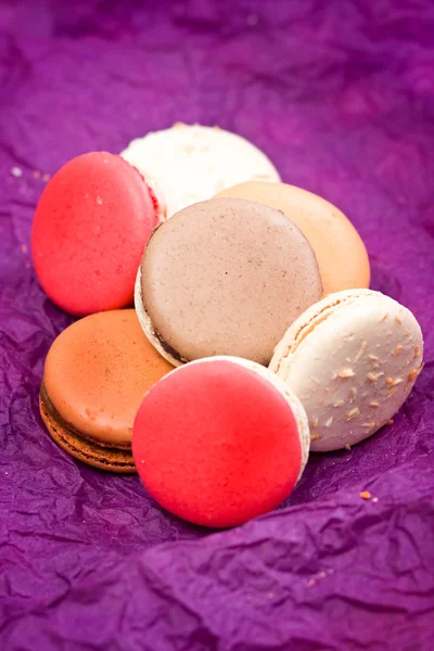 French colorful macarons on violet background — Stock Photo, Image