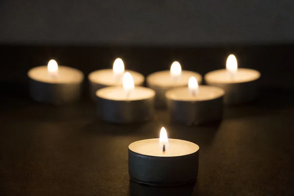 Queimando tealights na escuridão com textura — Fotografia de Stock