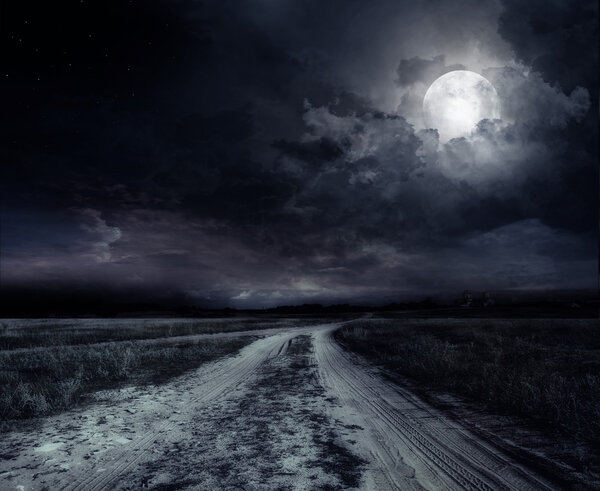Country road at night with large moon