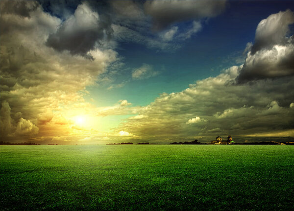 Bright sunset over green field.
