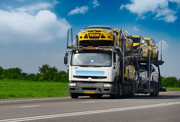 De trailer vervoert auto's op de snelweg — Stockfoto