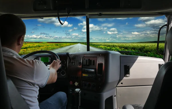 The truck driver on the road among fields highway. business trip — Stock Photo, Image