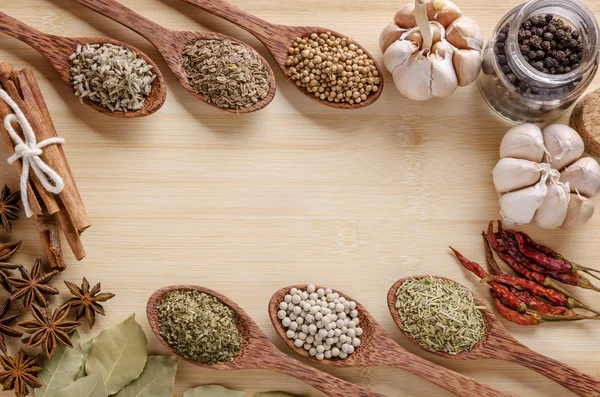 Spoons and spices on cutting board — Stock Photo, Image