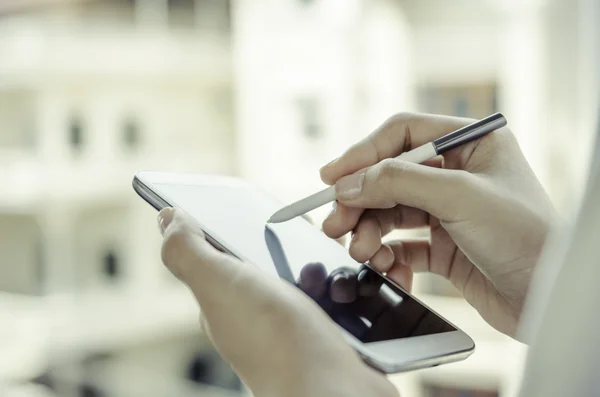 A woman using tablet with stylus pen — Stock Photo, Image