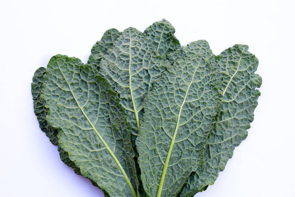 Fresh organic green kale leaves on white background.