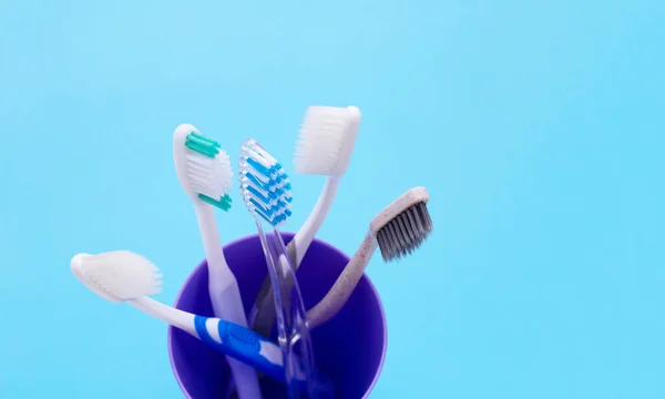 Cepillos Dientes Vidrio Plástico Sobre Fondo Azul Copiar Espacio — Foto de Stock