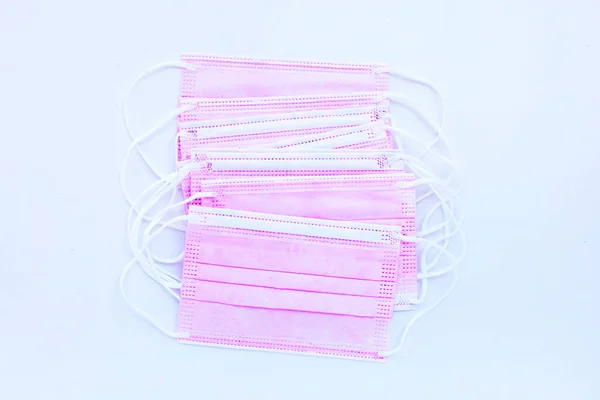 Pink protective medical masks on white background. Top view