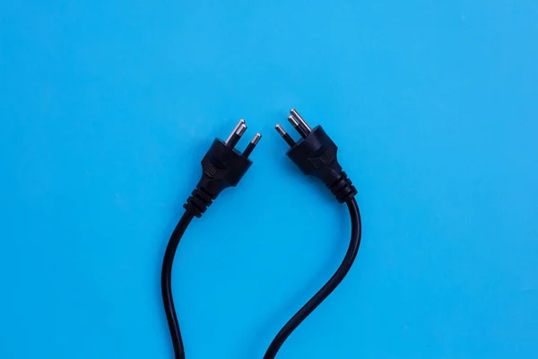 Electric plugs on blue background. Top view