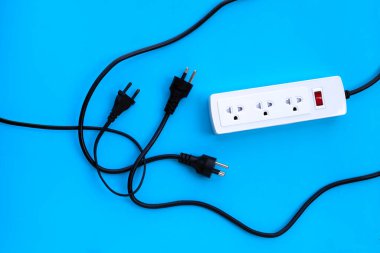 Elektrik kablosu ve fişi mavi arka planda. Üst görünüm
