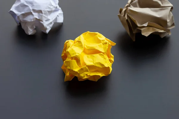 Crumpled paper balls on dark background. Copy space