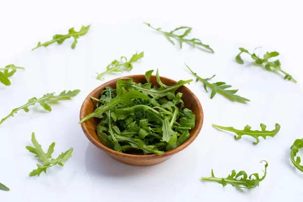 Fresh green rocket salad on white background.