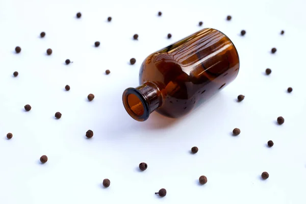Medicine Bottle with allspice isolated on white background