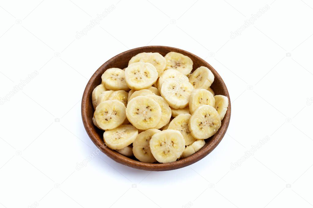 Banana slices in wooden bowl on white background.