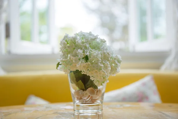 Artificial flowers on the dining room table — Stock Photo, Image