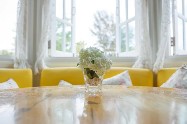 Artificial flowers on the dining room table — Stock Photo, Image