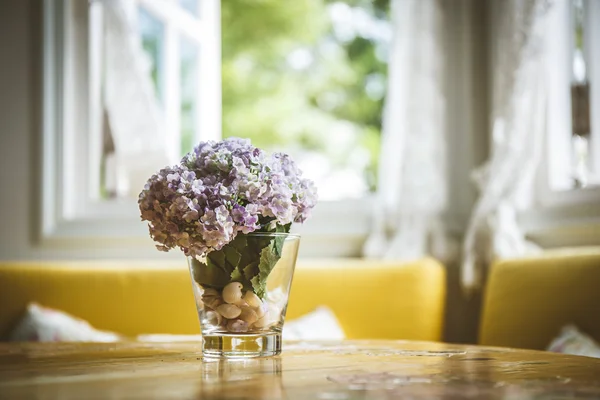 Artificial flowers on the dining room table — Stock Photo, Image