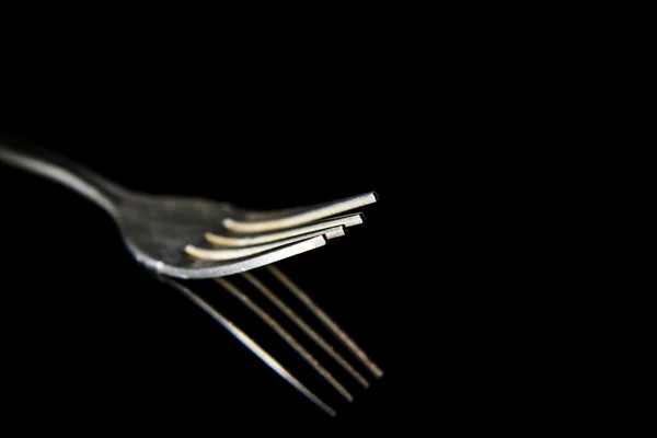 Tenedor aislado sobre un fondo negro — Foto de Stock