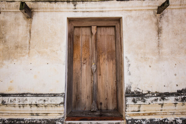 Wooden door frame in a antique sanctuary. Wat Putthaisawan, Ayut