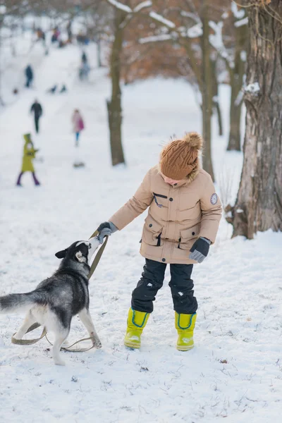 Ragazzo con il suo cane nella neve — Foto Stock