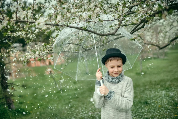 Boy in a hat with an umbrella — Stock Photo, Image