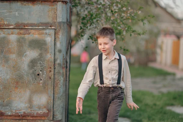 Boy in jeans with suspenders — Stock Photo, Image