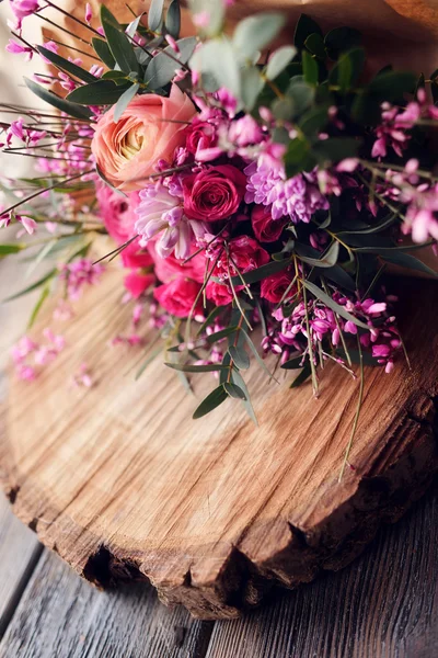 Bouquet of roses on wooden table — Stock Photo, Image