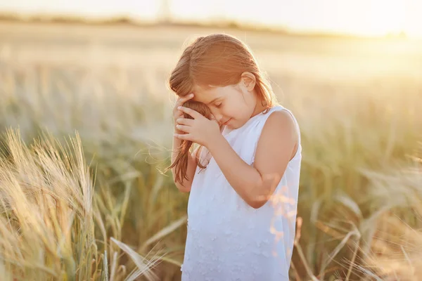 Menina pré-escolar em um campo de trigo maduro — Fotografia de Stock
